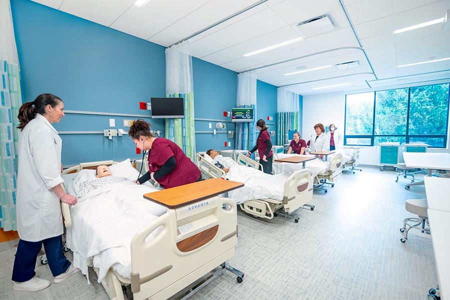 Nursing students practice in a hospital setting.