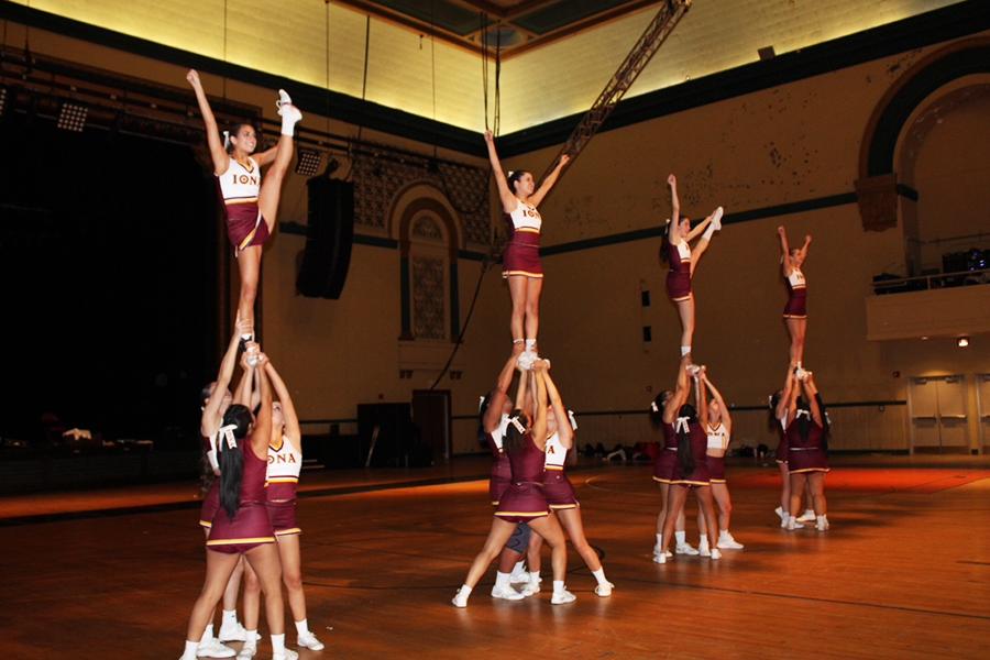 The cheer team completes four pyramids at a competition.