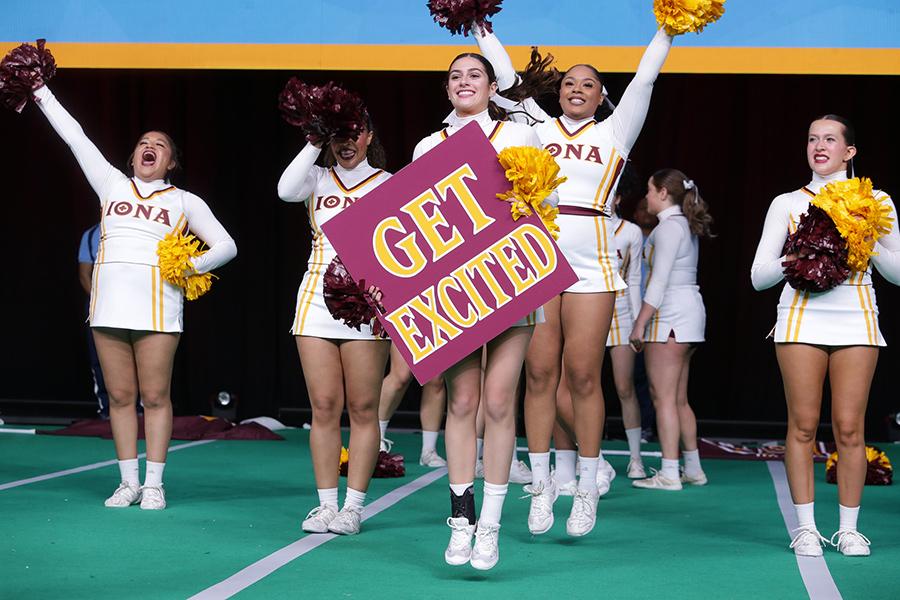 The cheer team hold a Get Excited sign as they compete at the nationals.