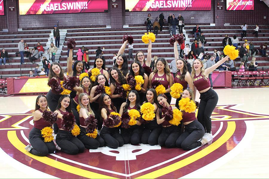 The dance team after a basketball game with Gaels Win on the scoreboards.