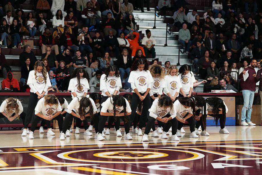 The dance team performs at an Iona basketball game.