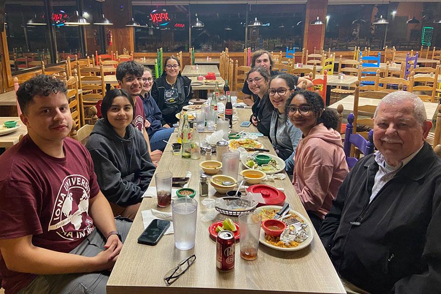 Office of Mission and Ministry students at dinner table during visit to Brownsville, TX