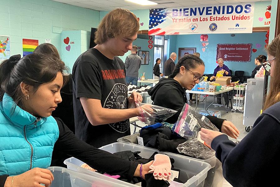 Office of Mission and Ministry students sifting through bins during visit to Brownsville, TX