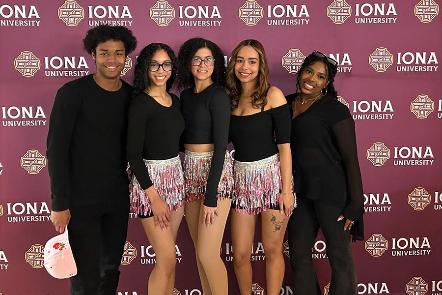 Four Bailando con Sazón members in front of the Iona step and repeat.