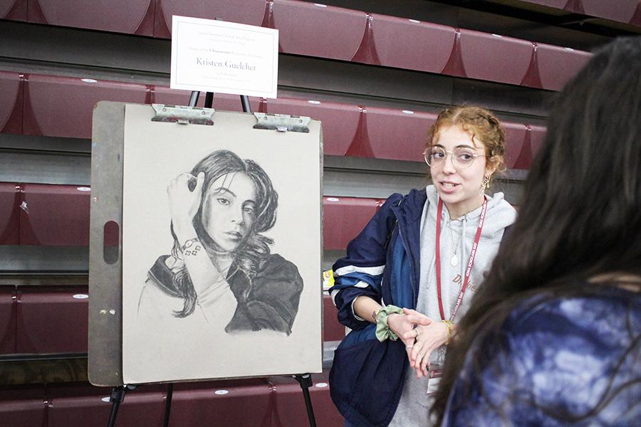 A student presenting her drawing at the 2024 ISD.