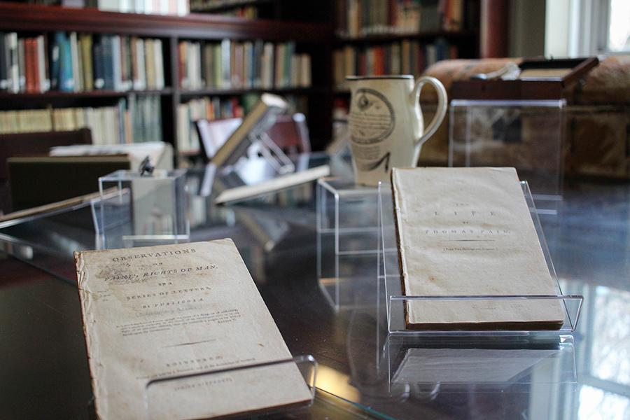 Thomas Paine books and items on a table.