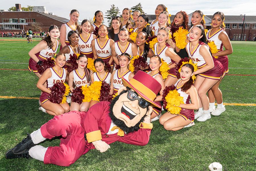 Group photo of the Iona Cheerleading Team and Iona's mascot Killian on the Mazzella Field during Homecoming Weekend 2025.