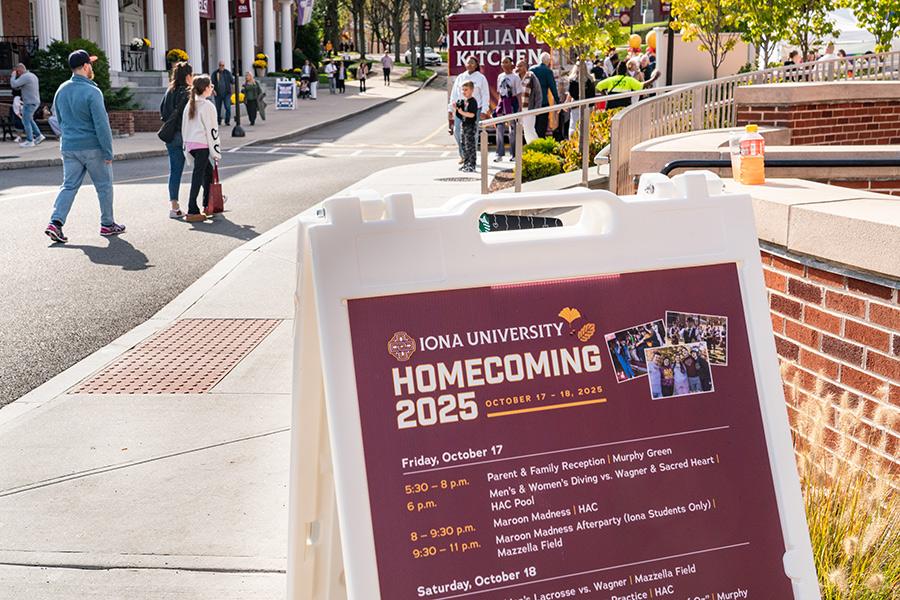 Poster board inside the Iona University New Rochelle campus, during Homecoming; with information about Homecoming Weekend 2025 with dates and events listed on the poster board.