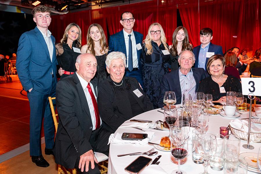 Iona alumni with their family, posing and smiling for a group photo at Iona University’s Alumni Awards & Homecoming Dinner.