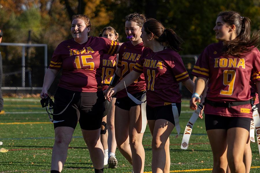 Iona University's Women's Club Flag Football team walking and smiling off the field.