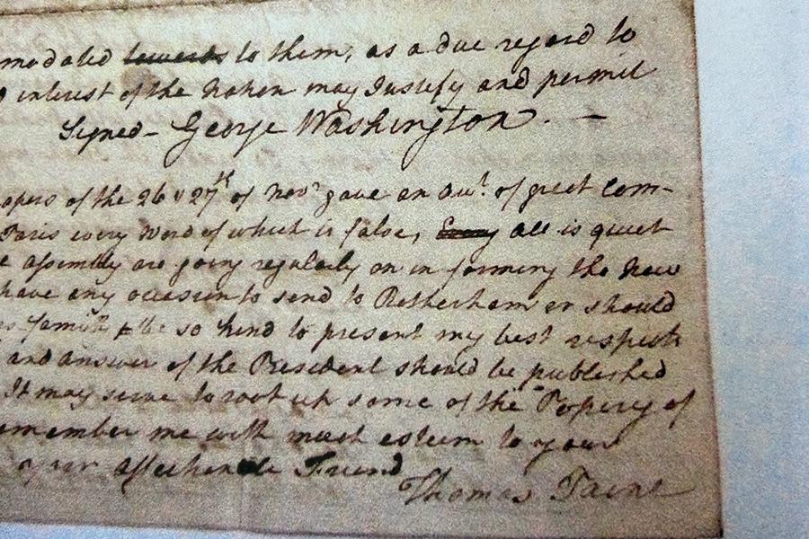 A piece of historical document that shows Thomas Paine's writing and signature at the bottom of the document.