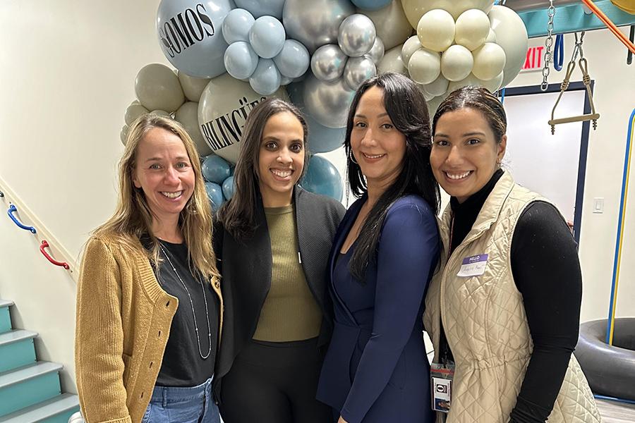 Jaridy Fabré standing with faculty and members for a group photo.
