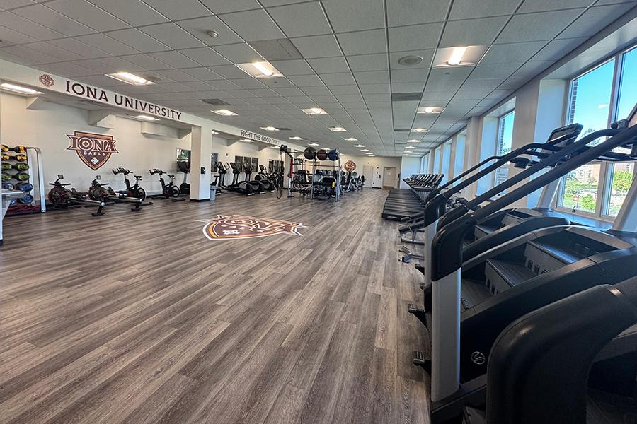 The cardio room featuring several stairmaster machines.