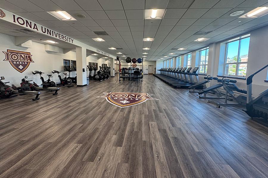 Wide photograph of the Cardio Room that features several treadmills.