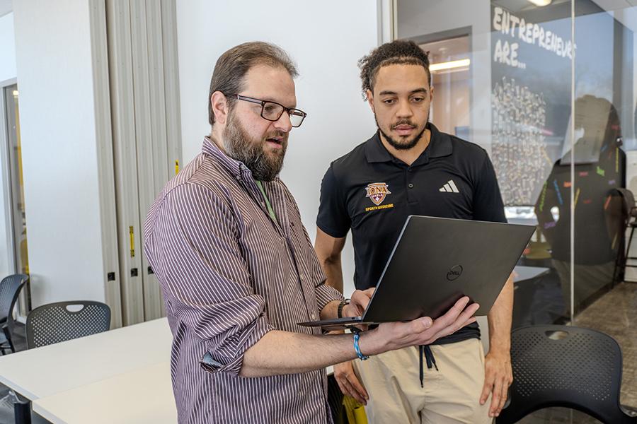 Rob Kissner works with a student for AI@Iona.