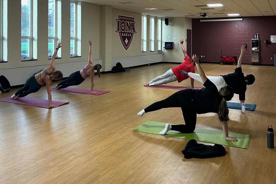 A group of students doing yoga inside the Mulcahy Gym.