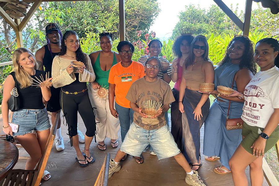 Iona students standing and posing for a group photo after weaving baskets.