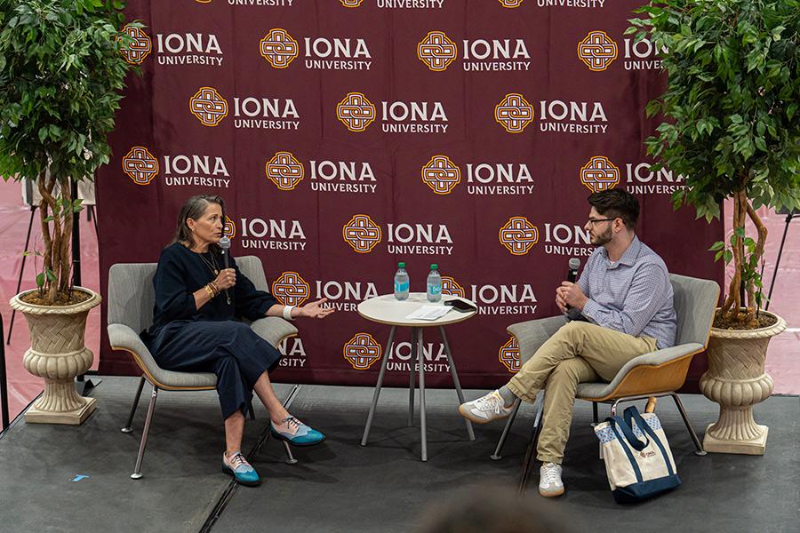 Keynote speaker of Iona Scholars Day 2026, Amy Emmerich, sitting and speaking into microphone.