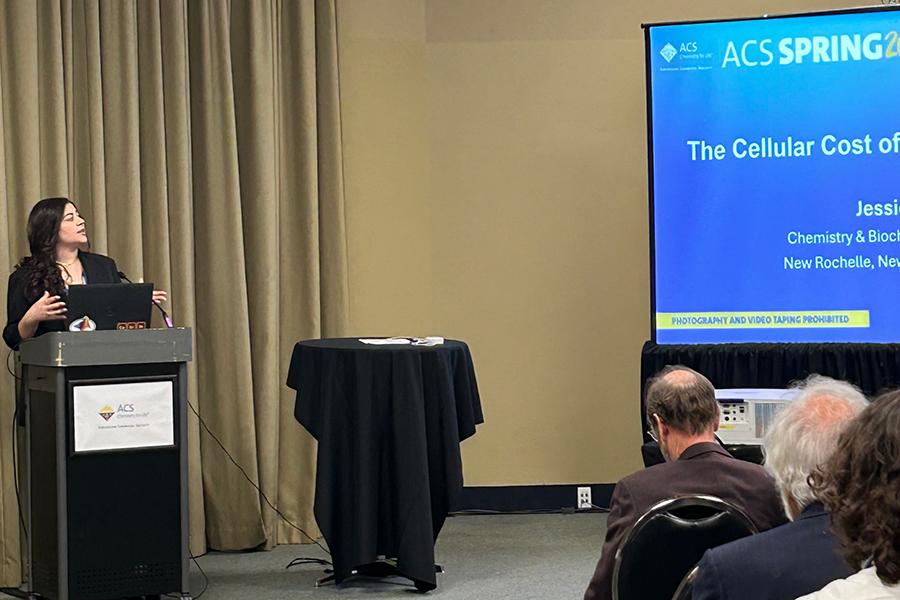 Jessica Said speaking at the podium in the ACS National Meeting.