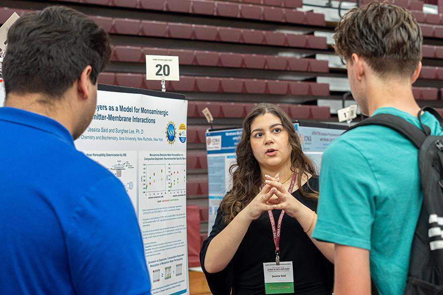 Jessica Said speaking with two students at Iona Scholars Day.