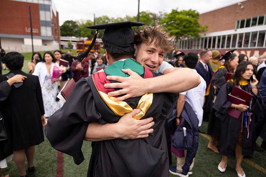 Two brothers embrace at the Commencement ceremony.