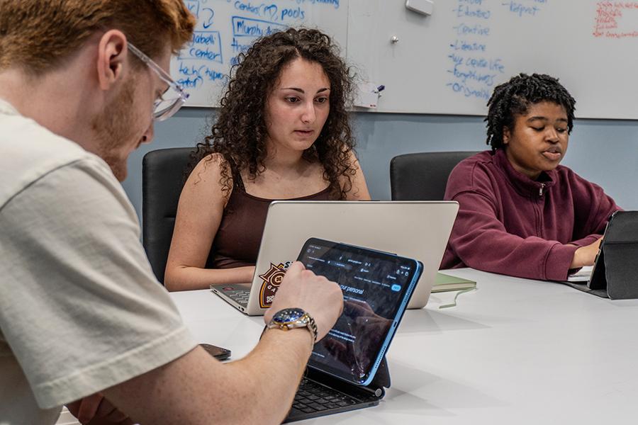 Students work together in a conference room for Education in Real Life.