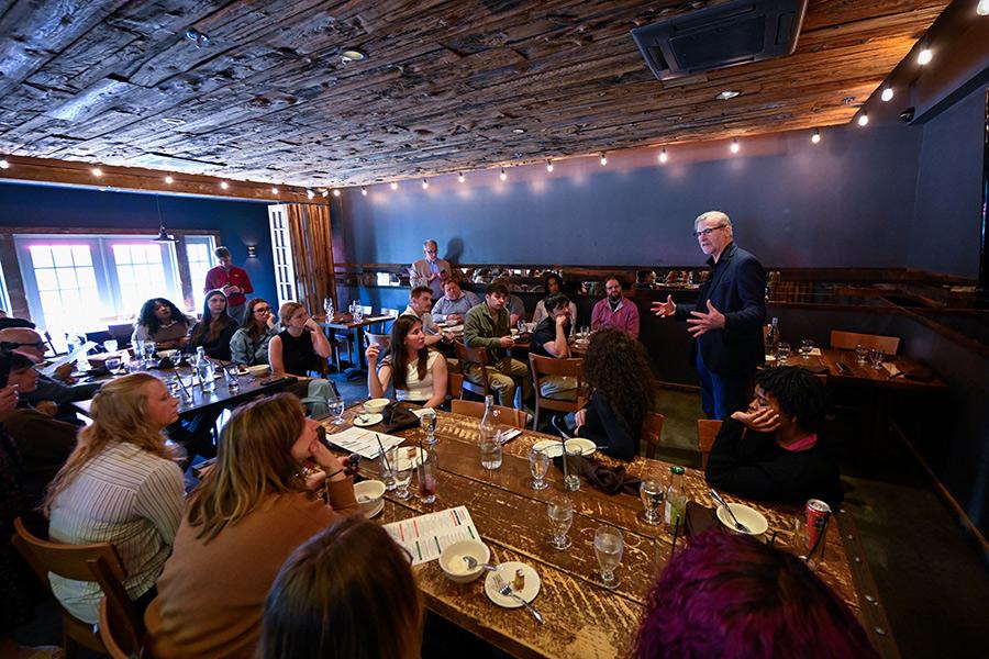 John Crabtree and students meet in the dining area.