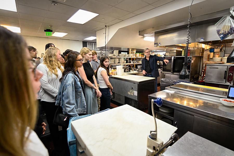 John Crabtree teaches students about the kitchen in his restaurant.