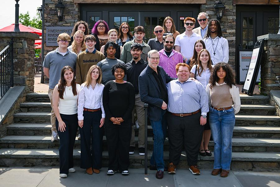 John Crabtree with Iona students and faculty outside one of his restaurants.