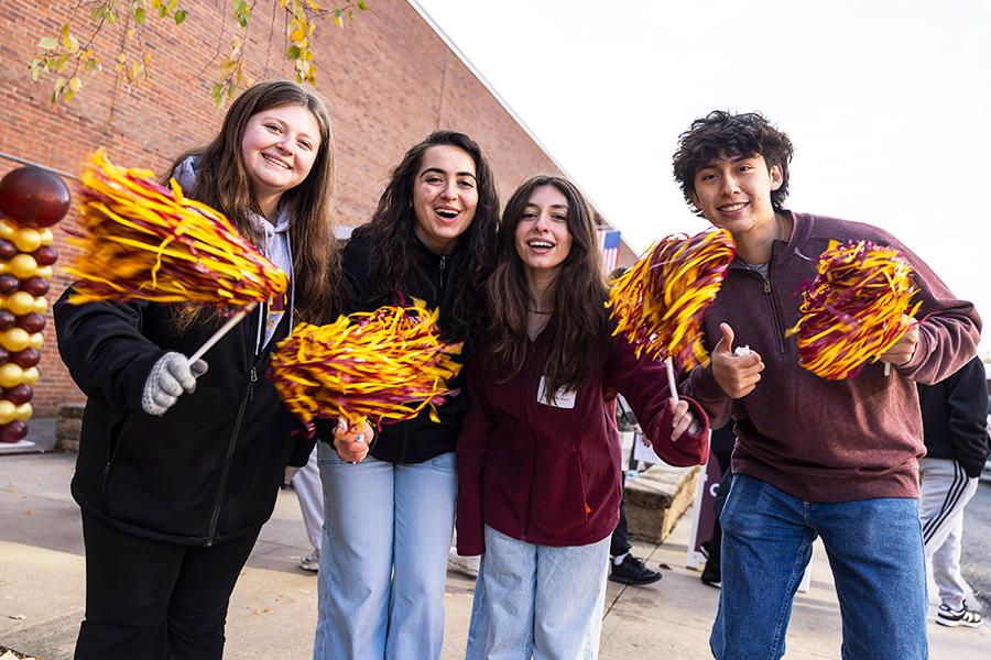 Students wave pom-poms and greet students for Open House.