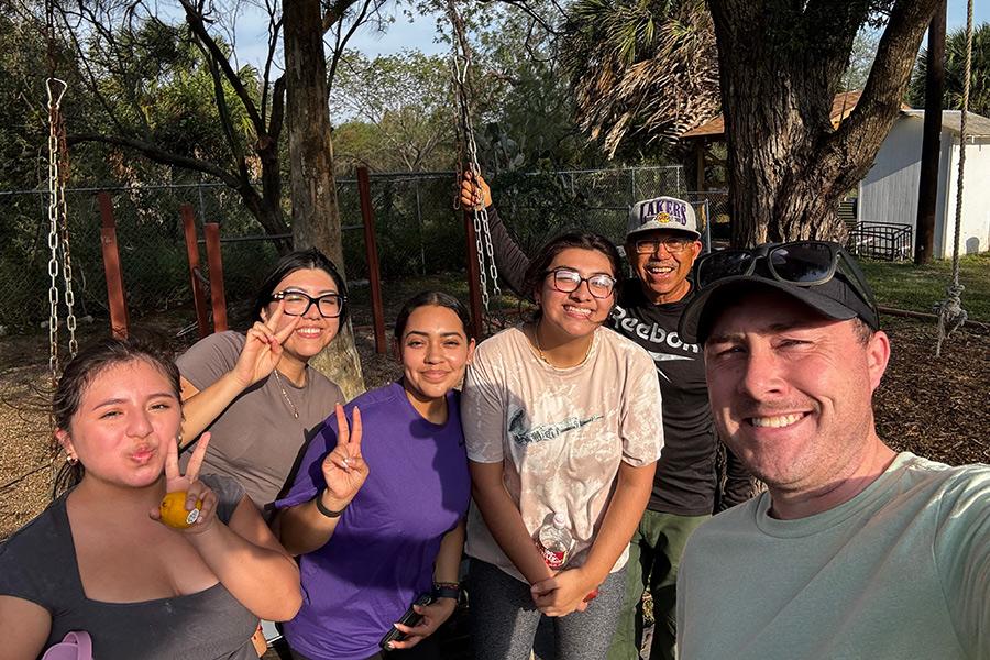 Students and faculty smiling together outside on an Iona University immersion trip.