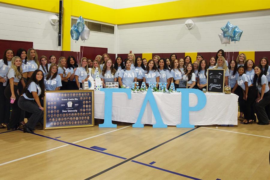 Gamma Lambda Rho in Mulcahy Gym at a table with their logo.