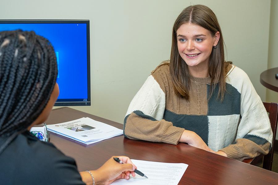 A human resources professional works with a job candidate.