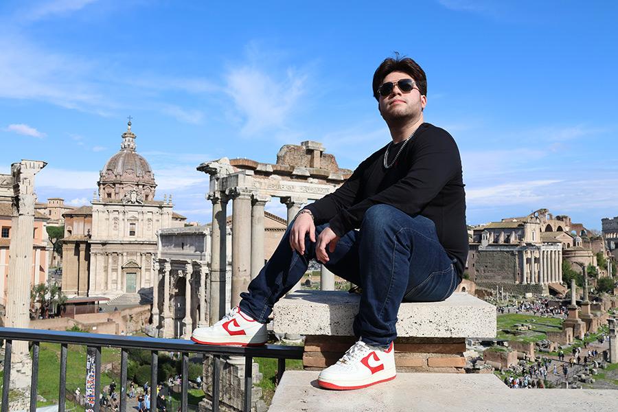 A student in Rome with the Colosseum in the background. 