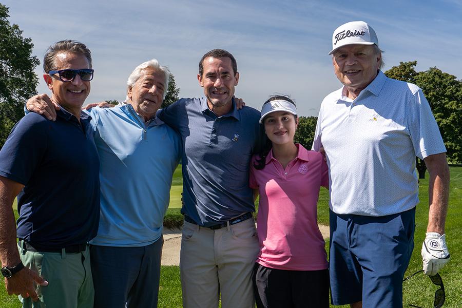 Board members and supporters smile on the course. 