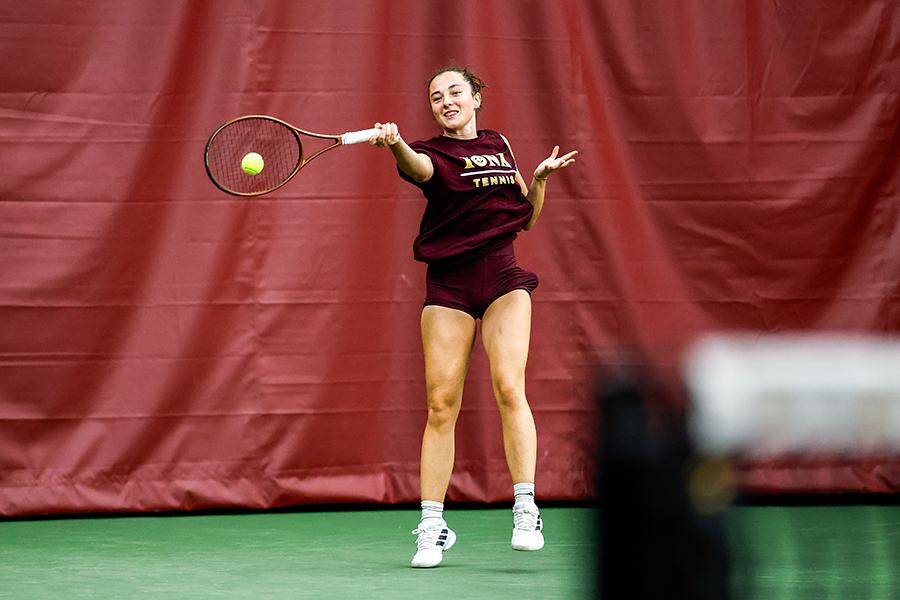 An Iona women's tennis athlete returns a serve during practice.