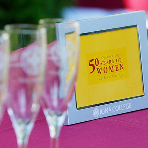 A plaque commemorating 50 Years of Women on a table at the kickoff celebration.