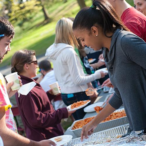 Students line up at the buffet to help themselves to delicious food at a Mission and Ministry hospitality supper.