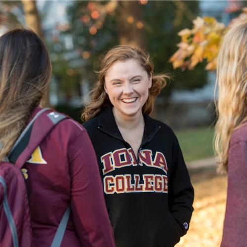 a female student smiling in a hoodie