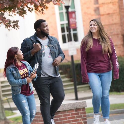 three students walking on campus