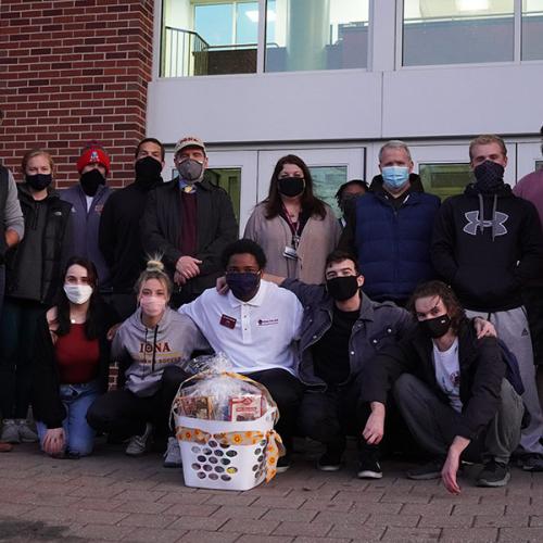 Volunteers stand outside of the Hynes Athletics center for the Thanksgiving Baskets 2020 ceremony.