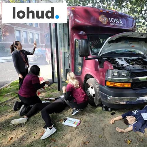 Nursing students at a bus accident simulation with the Lohud logo.