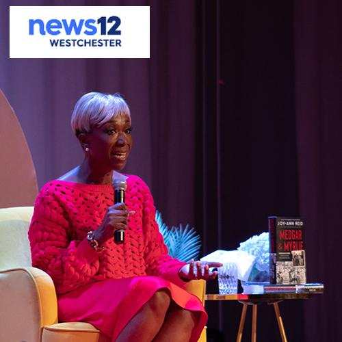 Joy Reid at her book launch with the News12 logo.