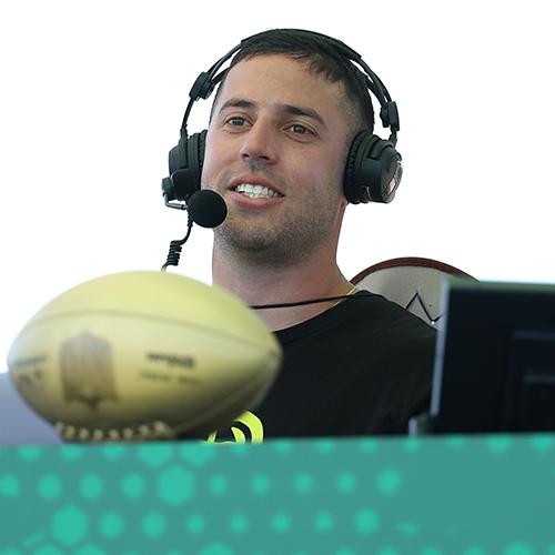 Tom Weingarten using a headset at a football game.