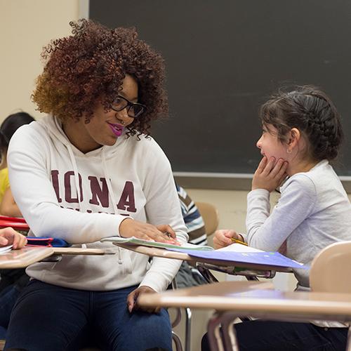 A literacy specialist works with a student in the classroom.