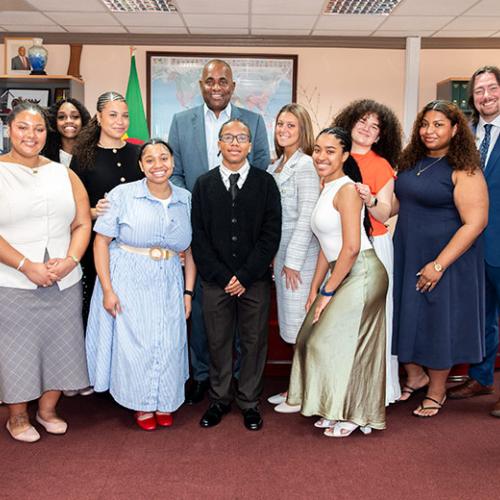 Iona University students and faculty posing for a formal group photo with Dominican Prime Minister Roosevelt Skerrit.