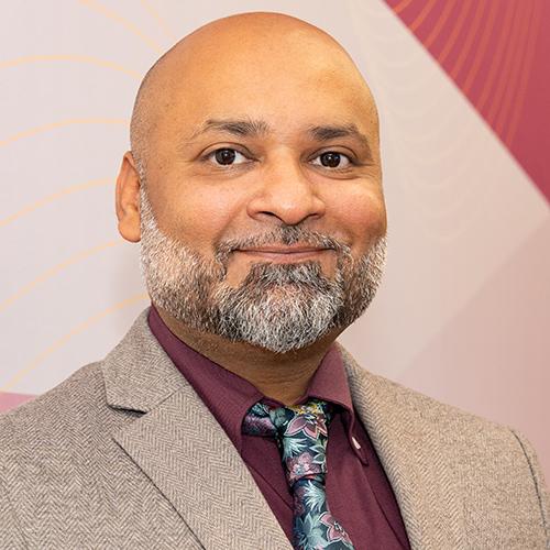 Binny Singh smiling for a headshot photo.