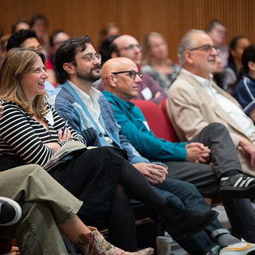 Faculty fellows sit in the audience at an Iona conference.