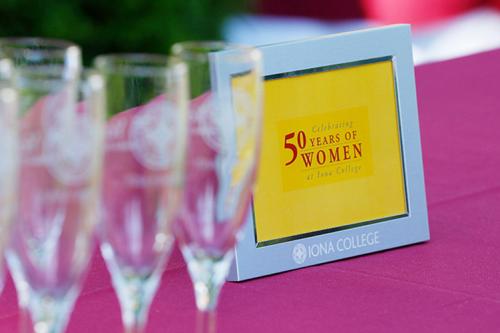 A plaque commemorating 50 Years of Women on a table at the kickoff celebration.