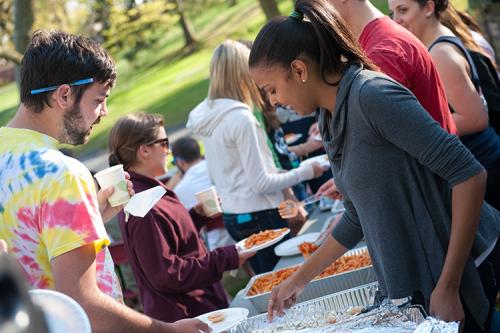 Students line up at the buffet to help themselves to delicious food at a Mission and Ministry hospitality supper.